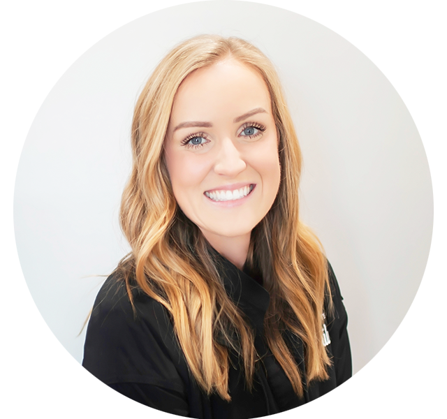 Emily, dental hygienist at Bass Dentistry, smiling warmly in a black uniform, providing gentle dental care in Gastonia, NC
