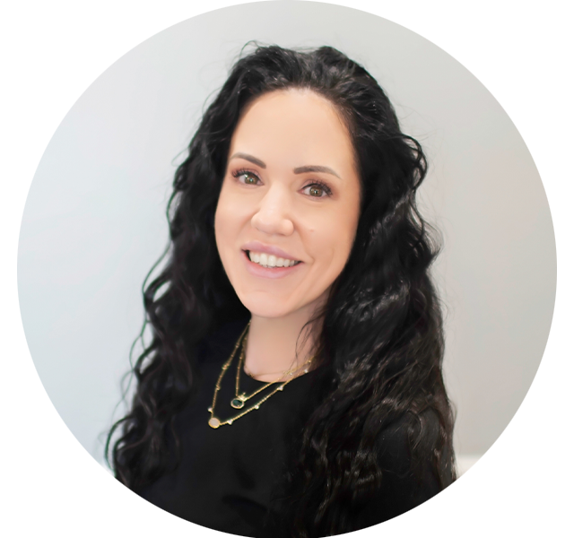 Heather, Office Manager at Bass Dentistry in Gastonia, NC, smiling warmly in a black uniform with long dark curly hai